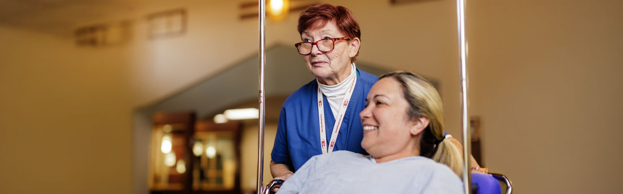 ennis caregiver pushing a patient in a wheelchair