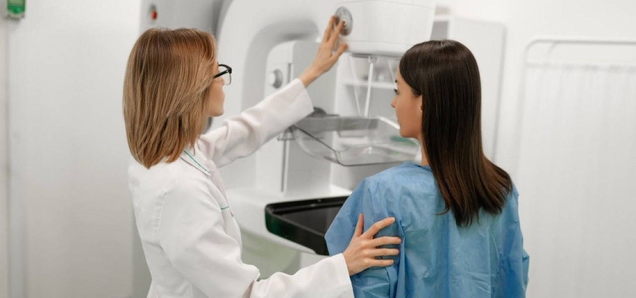 Caregiver giving patient a mammogram